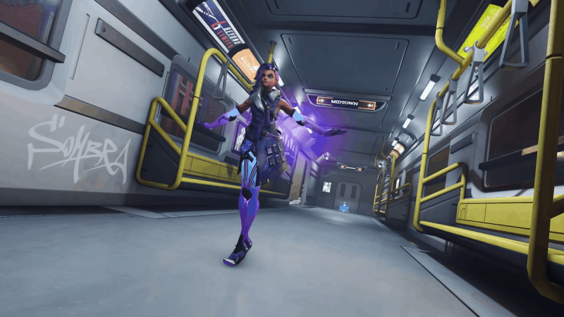Overwatch hero Sombra runs through an empty subway carriage, a faint purple glow surrounding her